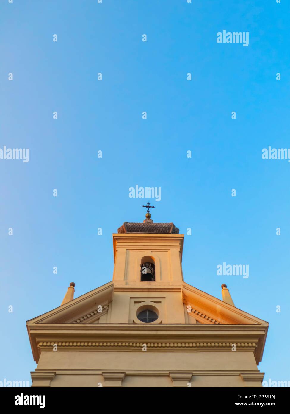 Campanile di una moderna chiesa urbana di Madrid sotto un cielo blu senza nuvole in una giornata estiva soleggiata Foto Stock