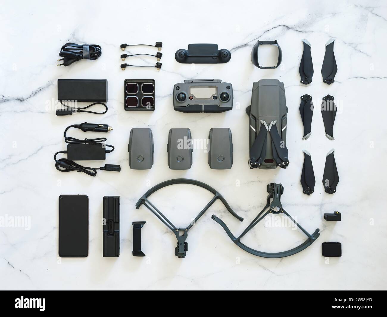 Set di droni pieghevoli o quadricotteri con molti accessori, vista dall'alto o piatto. Kit di drone pieghevole e attrezzatura per UAV su fondo in marmo bianco. Layout creativo Foto Stock