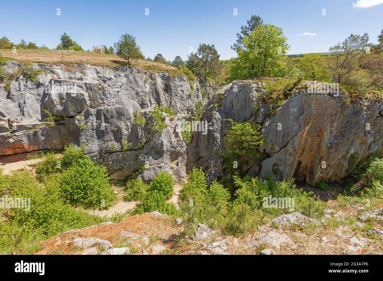 Guardando nel buco della fondry des chiens a Nismes. La fonderia proviene dalla fonderie francese perché il minerale di ferro dal buco di sinnio è stato fuso. Foto Stock