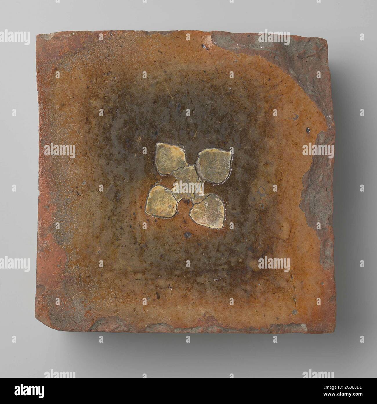 Mattonella da costruzione di una specie rossa con lati smussati e tacco superiore smaltato. Mattonella da costruzione di una specie rossa con lati smussati e tacco superiore smaltato. Sulla caduta superiore una croce con quattro bracci a forma di tiglio in terra bianca. Foto Stock