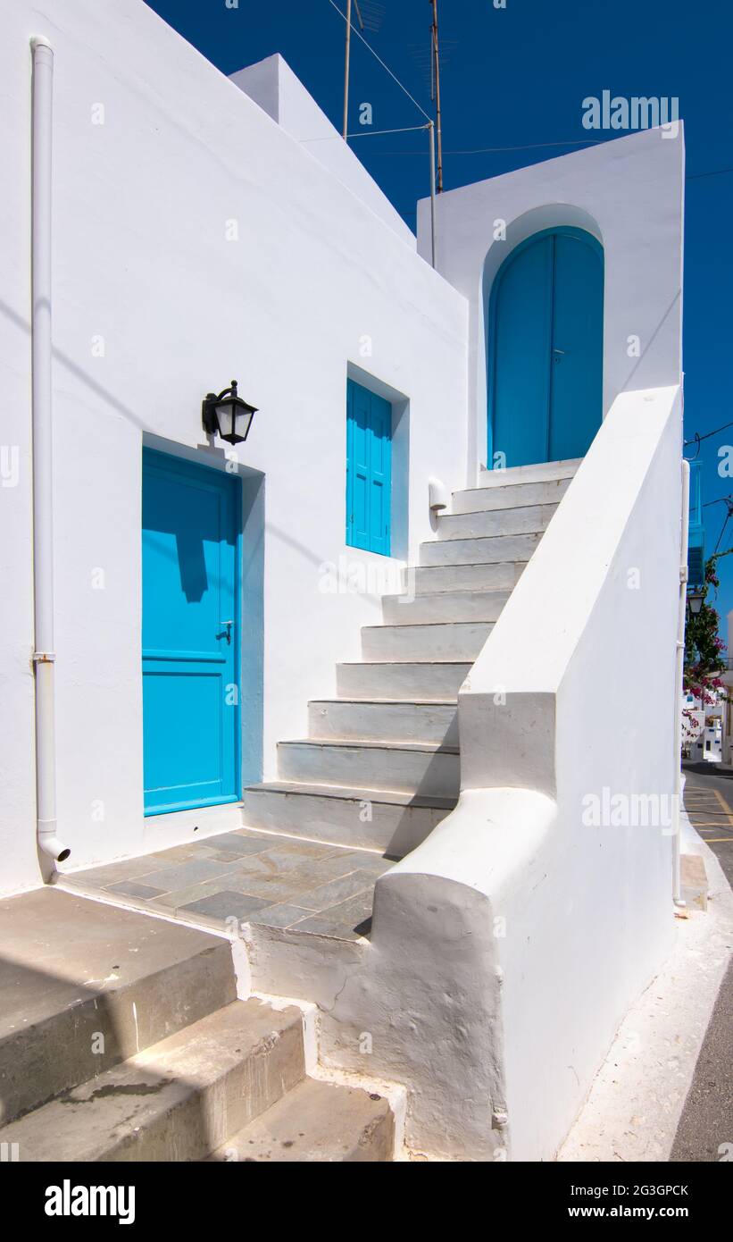 Scala a casa con porta blu e persiane in Grecia. Foto Stock