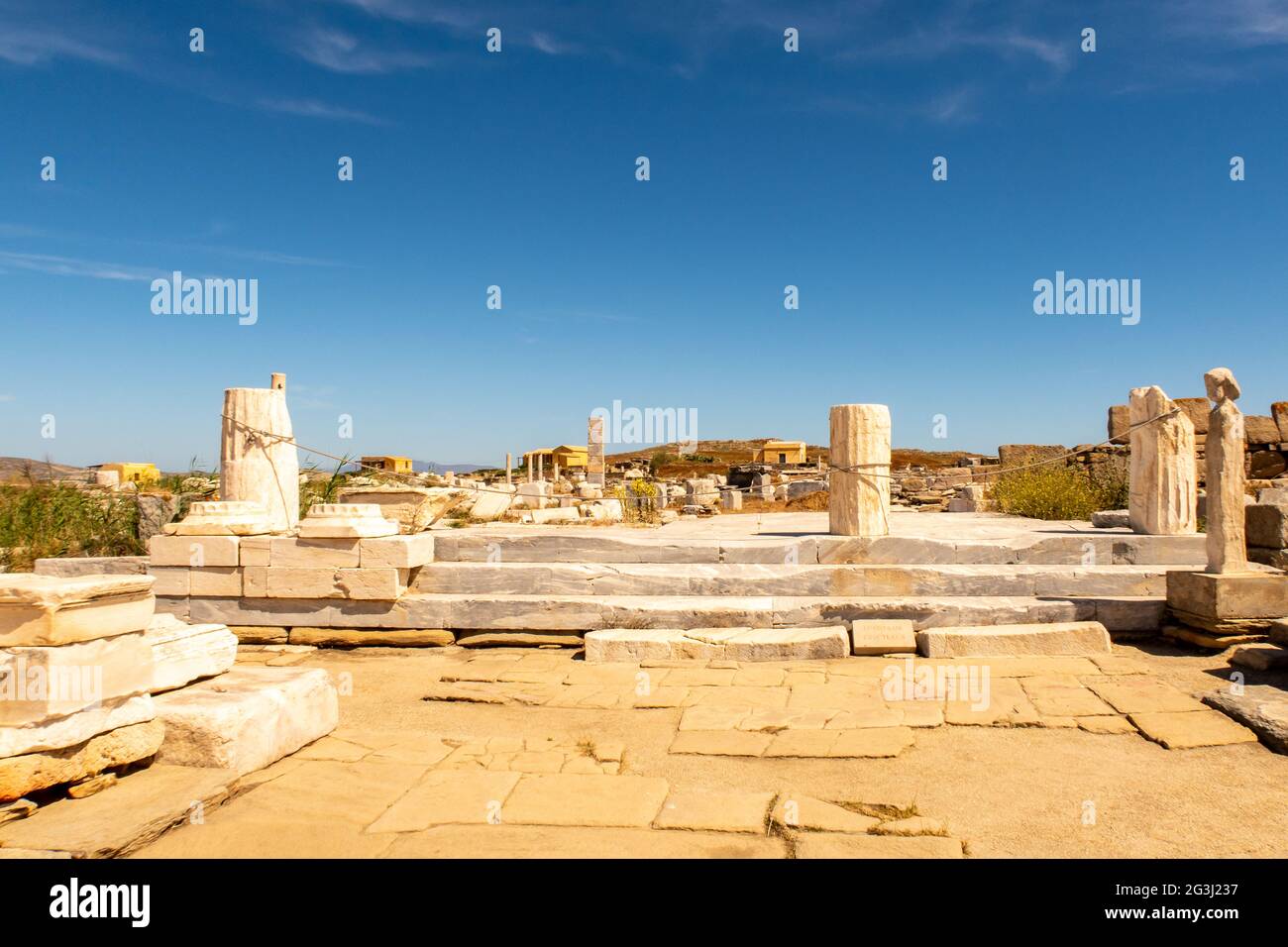 Rovine di un'antica città con pietre, colonne e templi sull'isola DI DELOS - sito mitologico, storico e archeologico in Grecia. Foto Stock