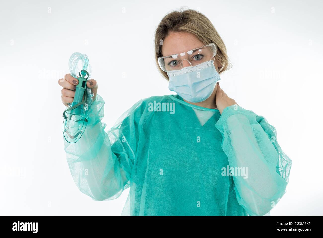 Ritratto di Doctor esausto in maschera protettiva per il viso che tiene il ventilatore non invasivo. Stress emotivo degli operatori sanitari di prima linea, COVID-1 Foto Stock