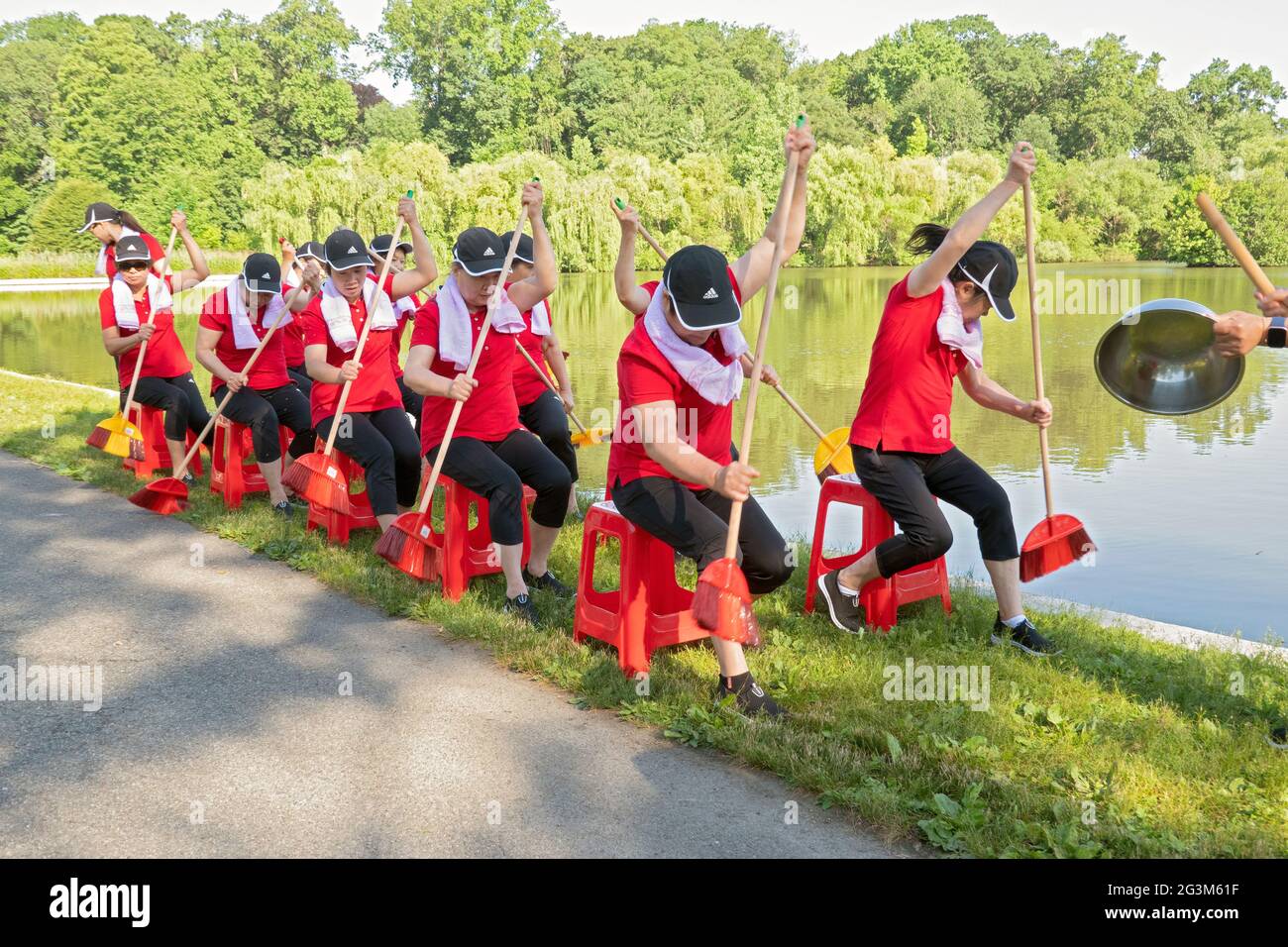 Artisti di danza cinese americana di mezza età provano una routine di canottaggio in un parco a Flushing, Queens, New York City Foto Stock