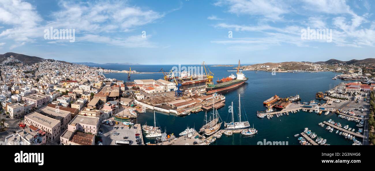 Isola di Syros, Grecia, Cicladi. Siros o città di Syra, cantiere navale di Neorion e vista panoramica del porto aereo drone, Ermoupolis panorama urbano, barche moo Foto Stock