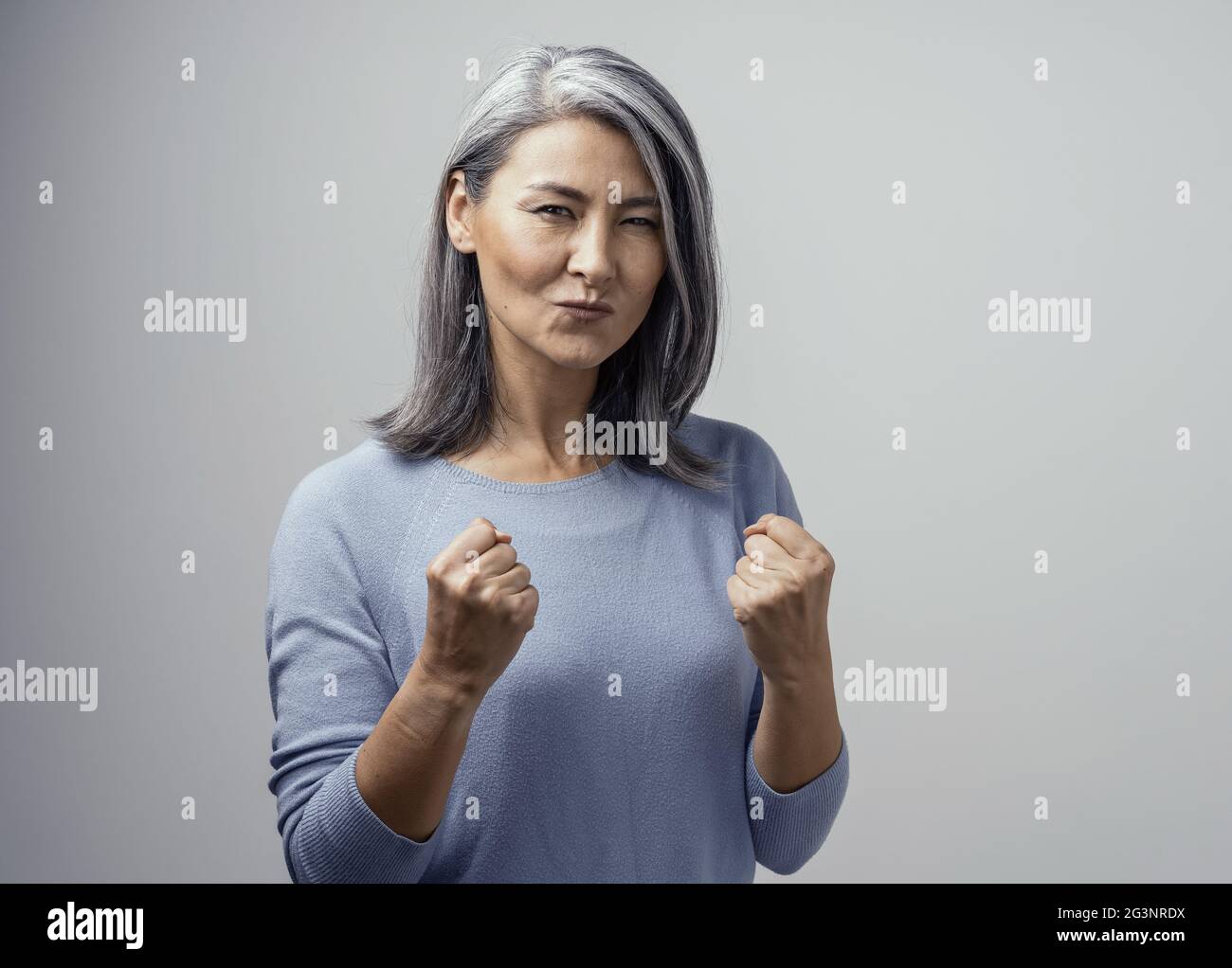 Bella donna asiatica in posa su sfondo bianco Foto Stock
