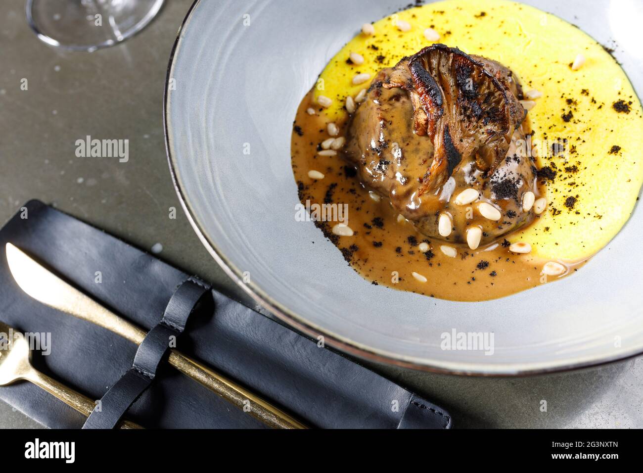 guancia di vitello al vino rosso con canosci cremosi e funghi di ostriche al forno Foto Stock