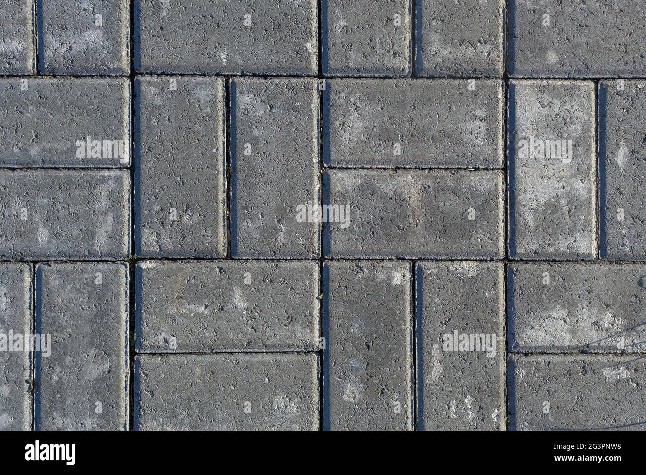 Struttura grigia di pietre da pavimentazione. Primo piano di piastrelle di pietra per marciapiedi Foto Stock