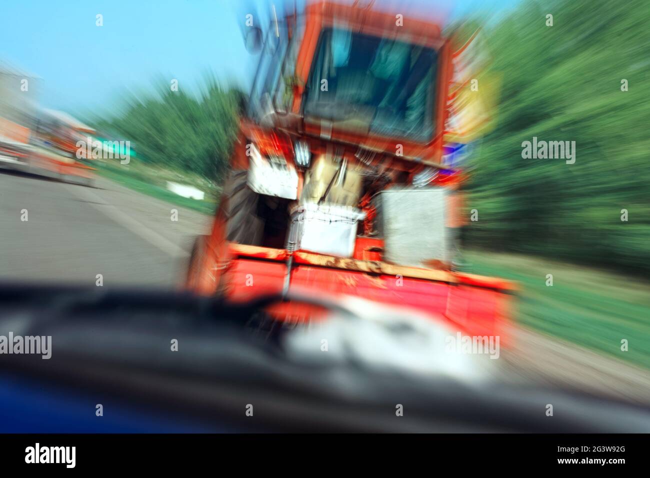 Situazione di emergenza su strada. Un trattore sfocato in movimento sulla superstrada. Foto Stock