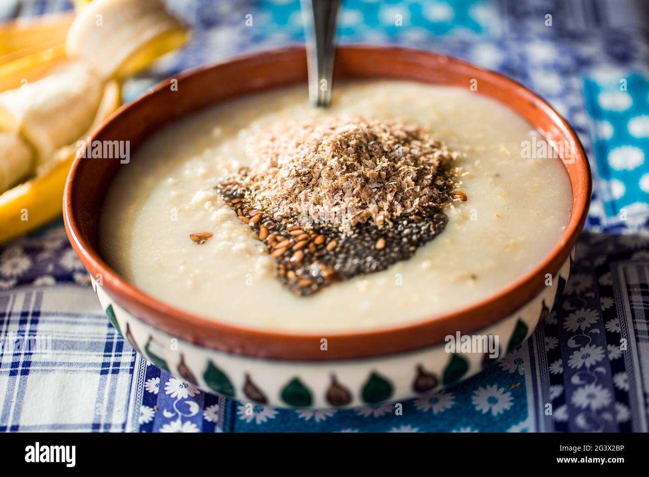 Primo piano di una colazione tradizionale - farinata d'avena con latte fatto in casa e kiwi dolce. Concetto - colazione in un caffè. Foto Stock