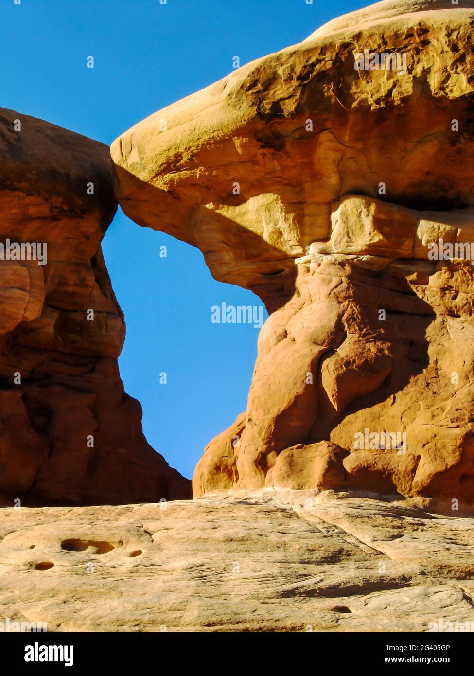 Un divario tra due Hoodoos in arenaria, formando una piccola finestra sul cielo blu, nel Devil's Garden, Escalante, Utah, USA Foto Stock