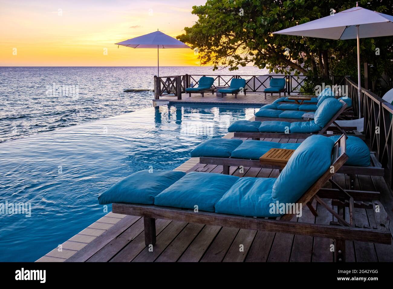 Rilassante spiaggia estiva, solarium e piscina privata con palme vicino alla spiaggia e vista panoramica sul mare a lusso ho Foto Stock