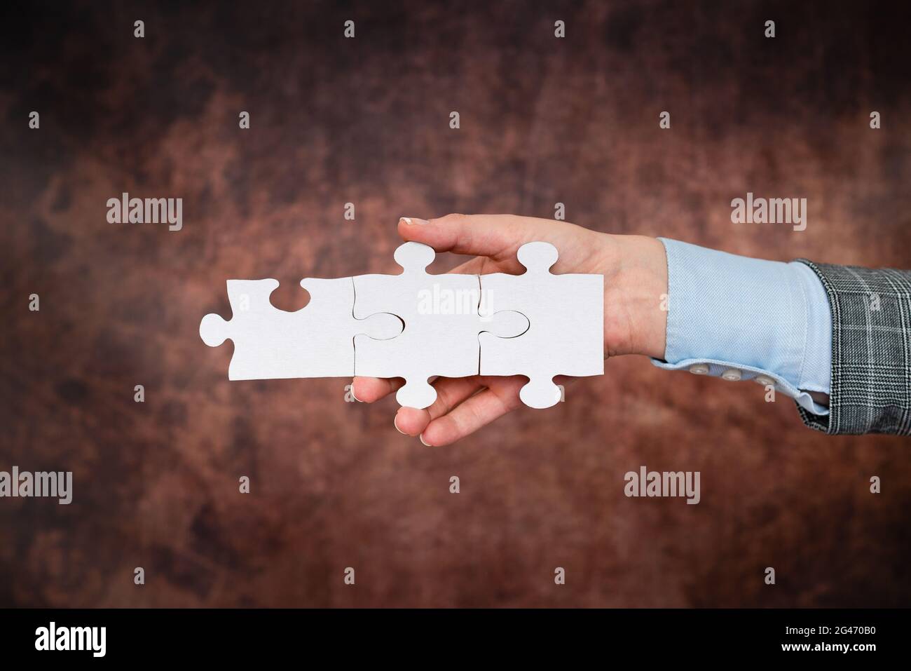 Mani che tiene due pezzi di Jigsaw Puzzle.Cooperation per trovare e risolvere le idee mancanti a work.businessman trovare strategia Foto Stock