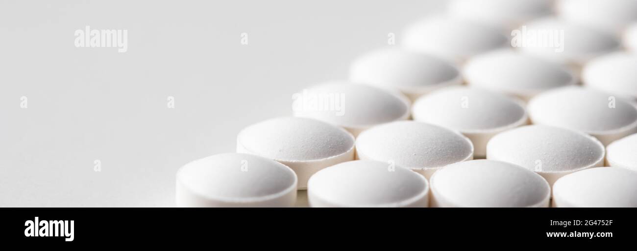 File di pillole su sfondo bianco. Sanità, medicina, farmacia e concetto di malattia Foto Stock