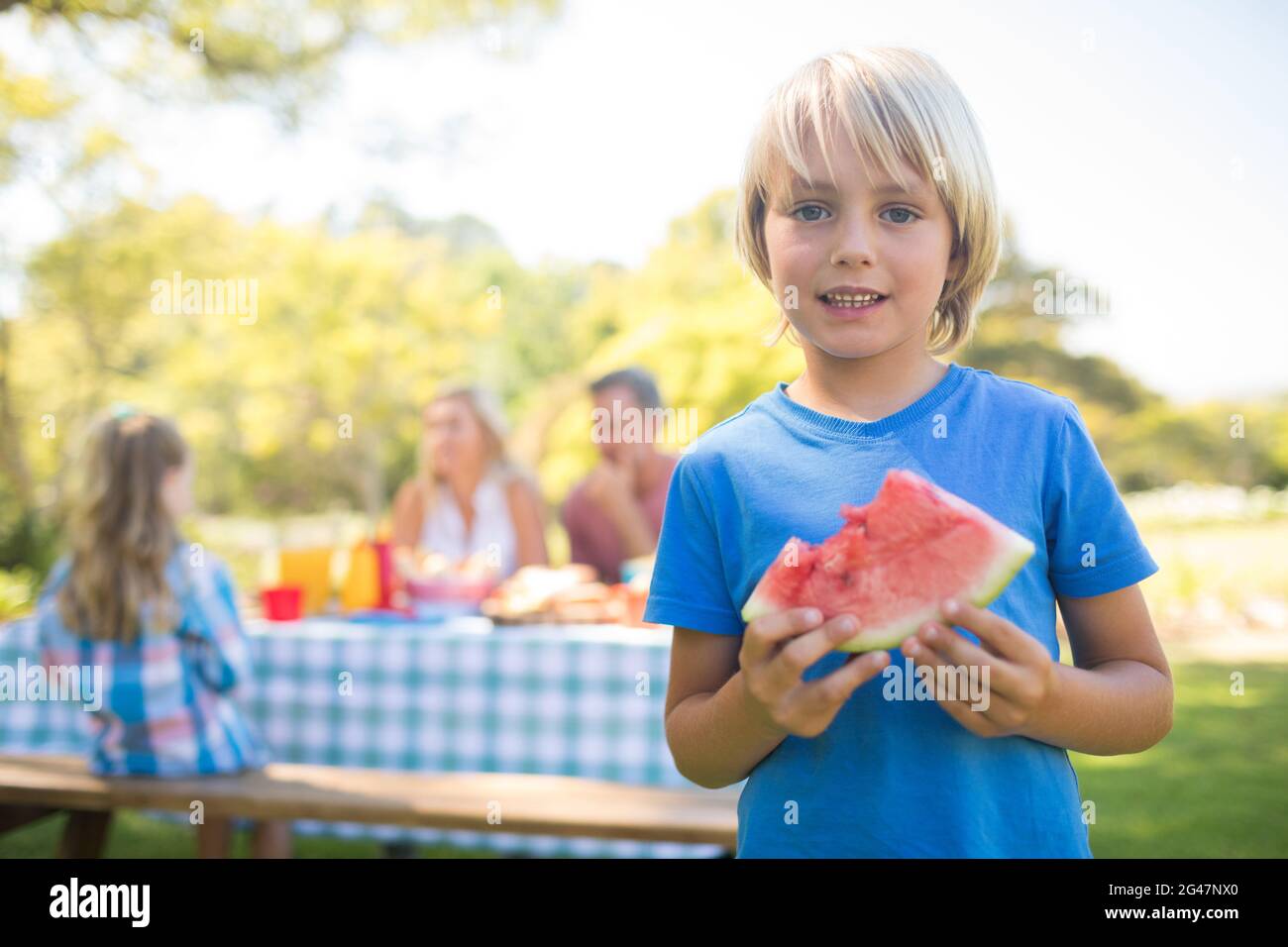 Ragazzo sorridente holding anguria nel parco Foto Stock