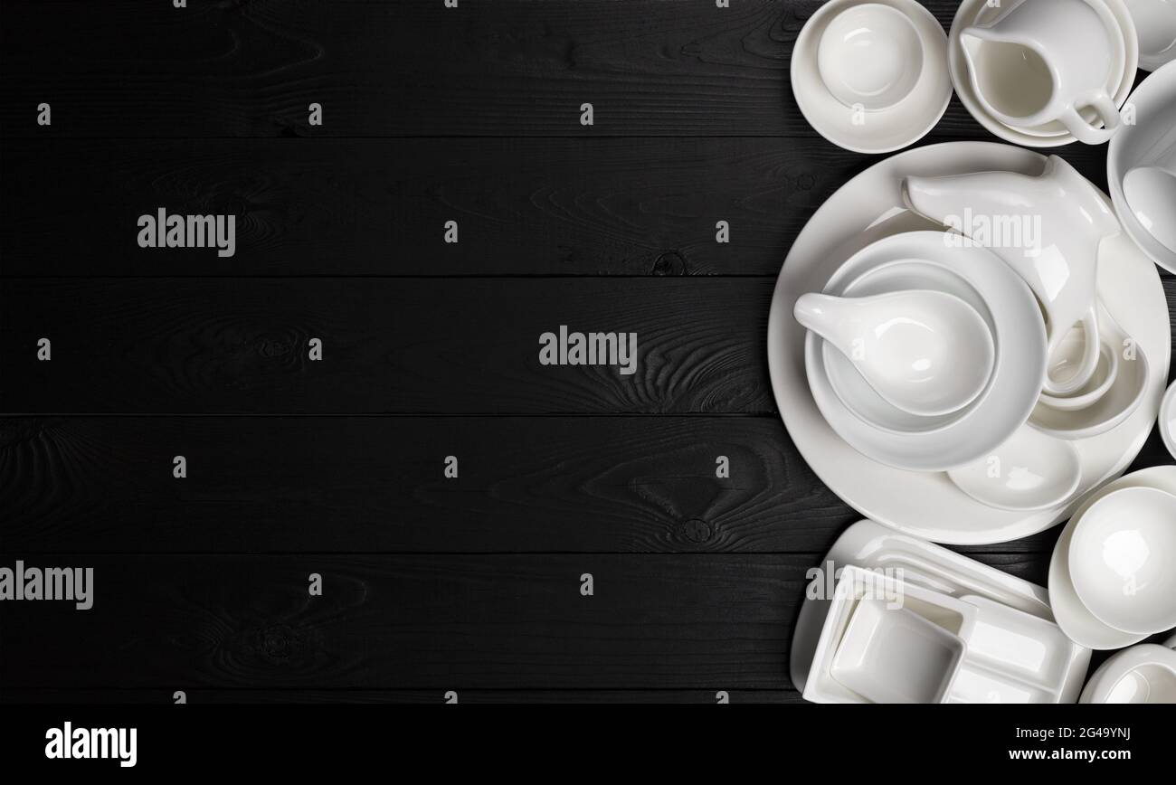 Set di stoviglie vuote su sfondo nero con spazio per la copia Foto Stock