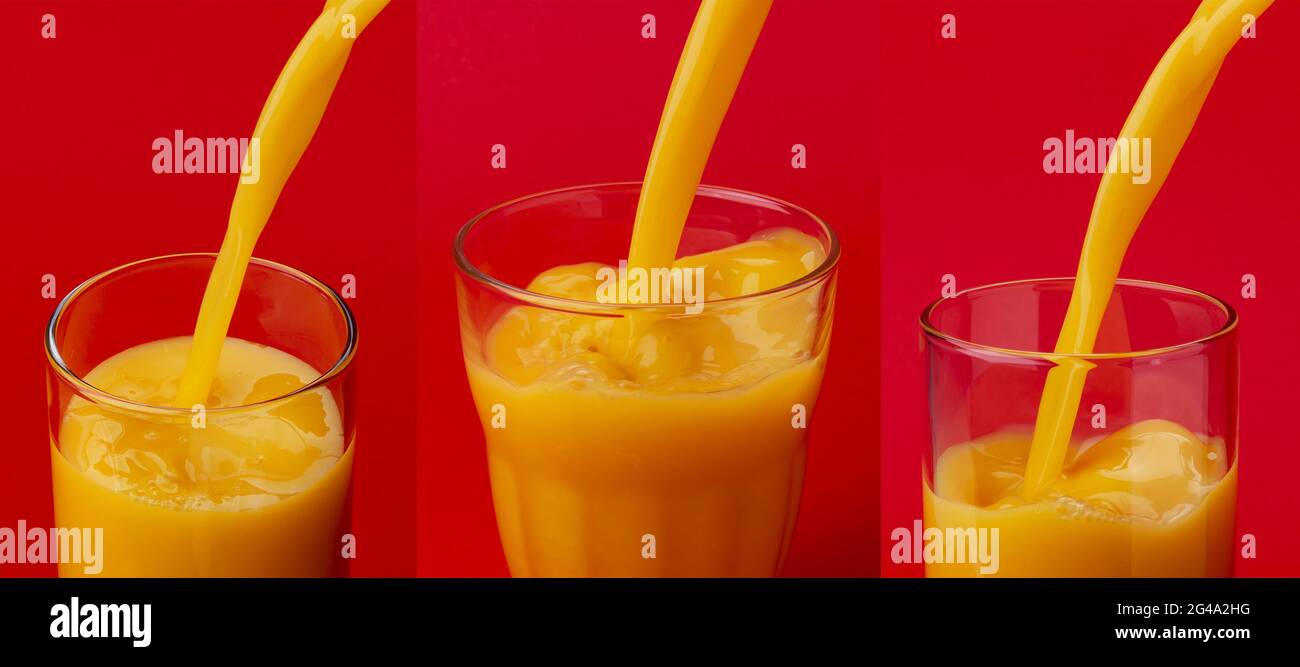Succo di arancia versando in vetro rosso sul colore di sfondo Foto Stock