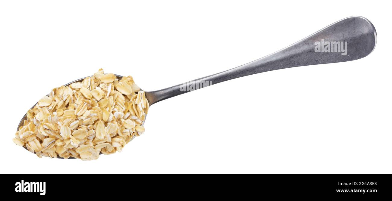 OAT flakes in cucchiaio isolato su sfondo bianco. Vista dall'alto Foto Stock