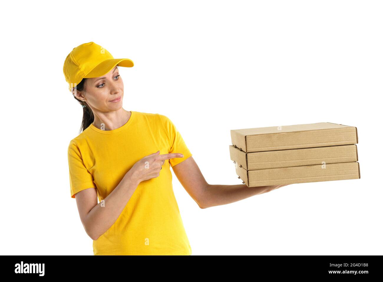 Una donna di consegna della pizza di aspetto caucasico in una uniforme gialla, tenendo scatole di cartone in mano su uno sfondo bianco. Foto Stock