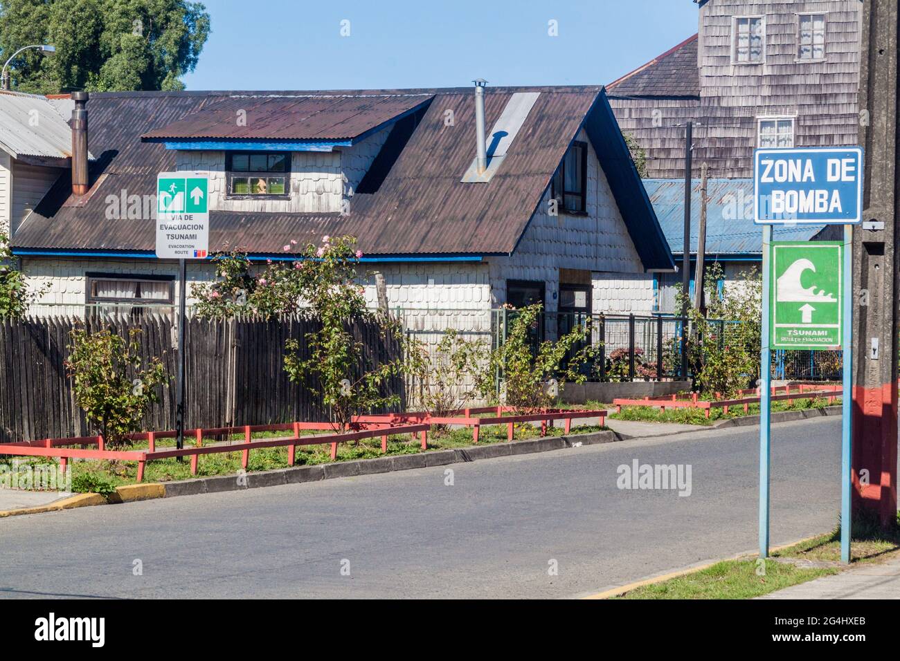 Cartelli per la zona di pericolo dello tsunami nel villaggio di Curaco de Velez, Cile Foto Stock