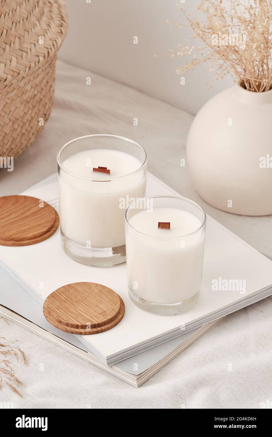 Candele profumate fatte a mano in un bicchiere con coperchio in legno.  Candele di cera di soia con uno stoppino di legno Foto stock - Alamy