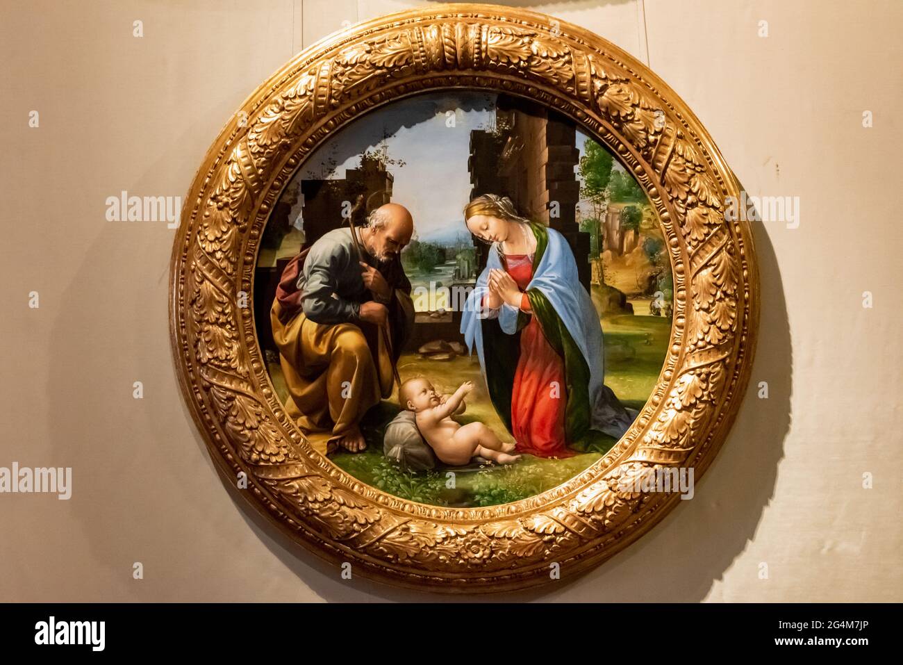 Dipinto medievale in una cornice rotonda che mostra la Vergine Maria e San Giuseppe guardando il bambino Gesù Foto Stock