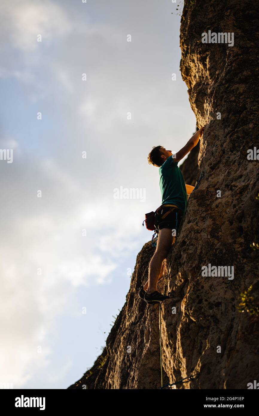 Arrampicarsi su una roccia durante l'ora d'oro in Spagna Foto Stock