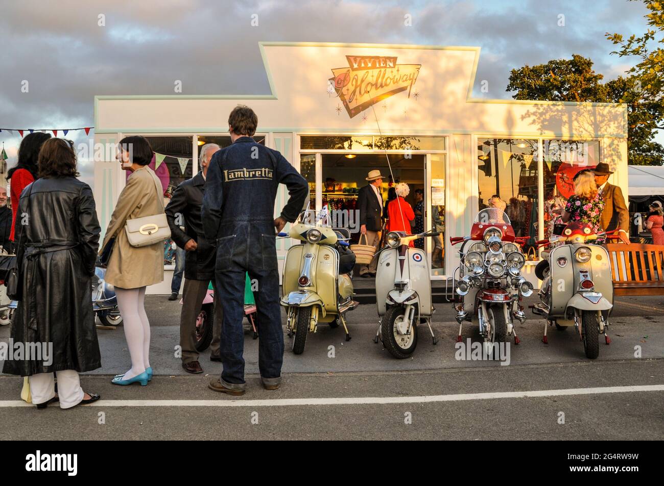 Ricreazione di un negozio di moda Vivien of Holloway al Goodwood Revival  2011, evento di nostalgia del Regno Unito. abbigliamento del periodo degli  anni '60. Persone e scooter a motore Foto stock - Alamy