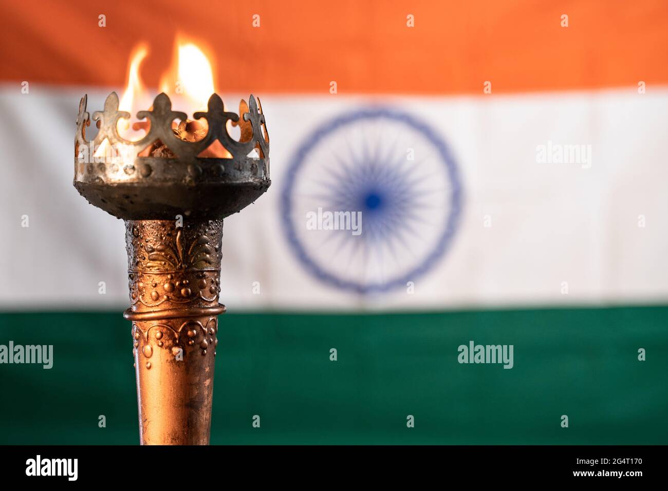 Primo piano di fiamma ardente su sport torcia realy con indiano come sfondo Foto Stock