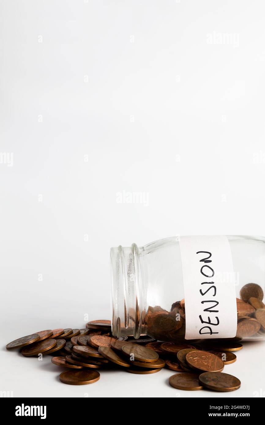 Monete di rame che fuoriescono da un vaso etichettato pensione. Pensione, finanziaria, risparmio, economia, concetto di investimento Foto Stock
