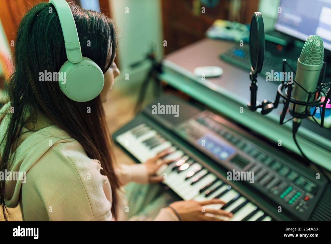 Musicista femminile che suona pianoforte in studio Foto Stock