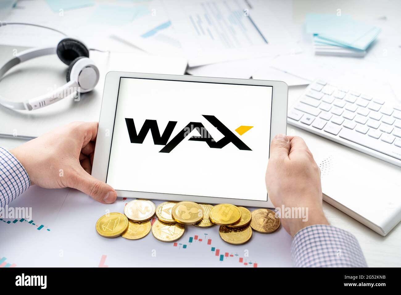 Russia Mosca 06.05.2021.Man compressa da tenere con logo di token, CERA criptovaluta. Moneta Crypto per l'estrazione in gioco online, piattaforme di gioco Alien World Foto Stock