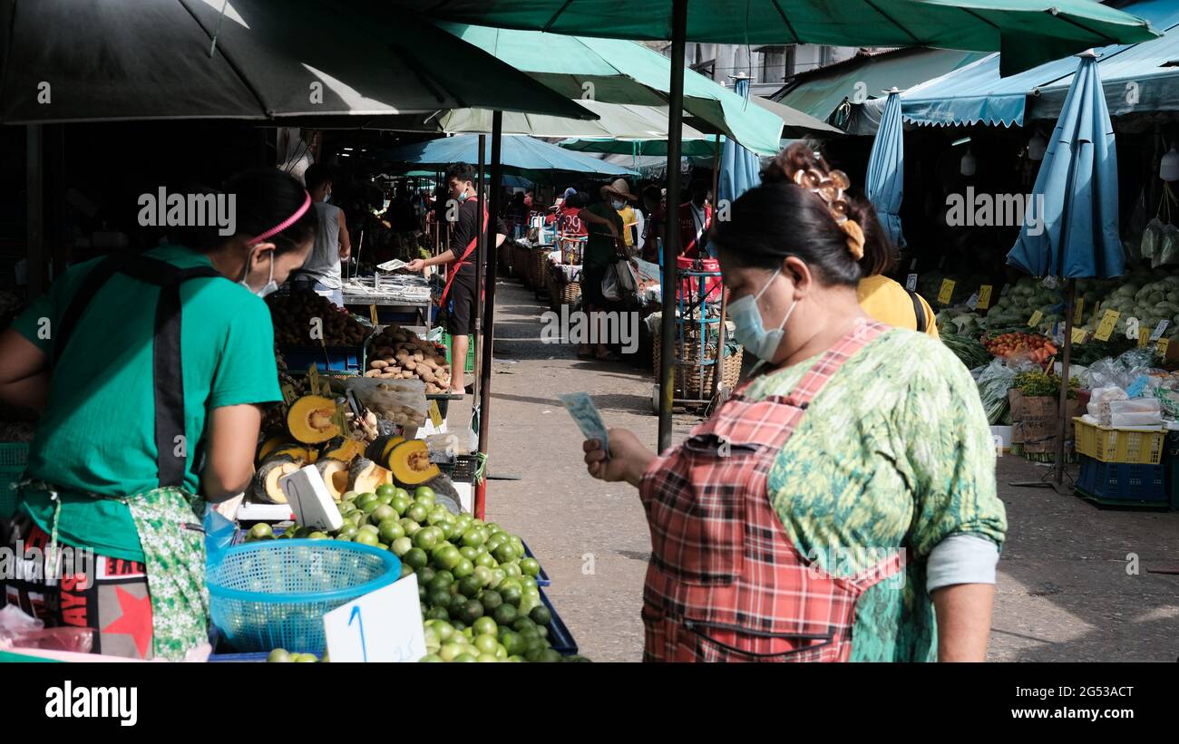 Compratore e venditore soldi autentici che cambiano le mani Klong Toey mercato BangkokThailandia l'economia delle vendite di cibo gente che compra il pranzo Rama 4 intersezione Foto Stock