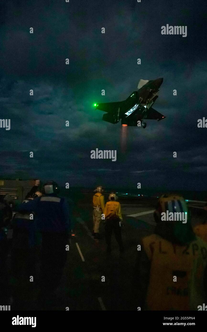 USA America, Giappone. 24 Giugno 2021. Un aereo da combattimento US Marine Corps F-35B Lighting II della 31esima unità di spedizione marina, effettua un atterraggio notturno sul ponte di volo della nave d'assalto anfibia USS America 24 giugno 2021 nel Mare della Cina orientale. Credit: Planetpix/Alamy Live News Foto Stock