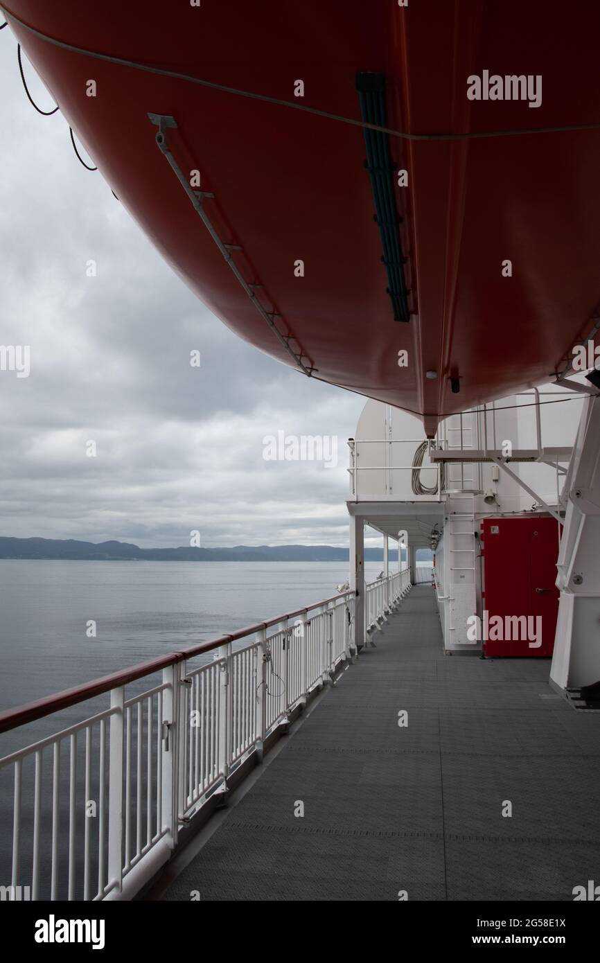 Una barca di vita sospesa sopra il ponte di una nave da crociera. Foto Stock