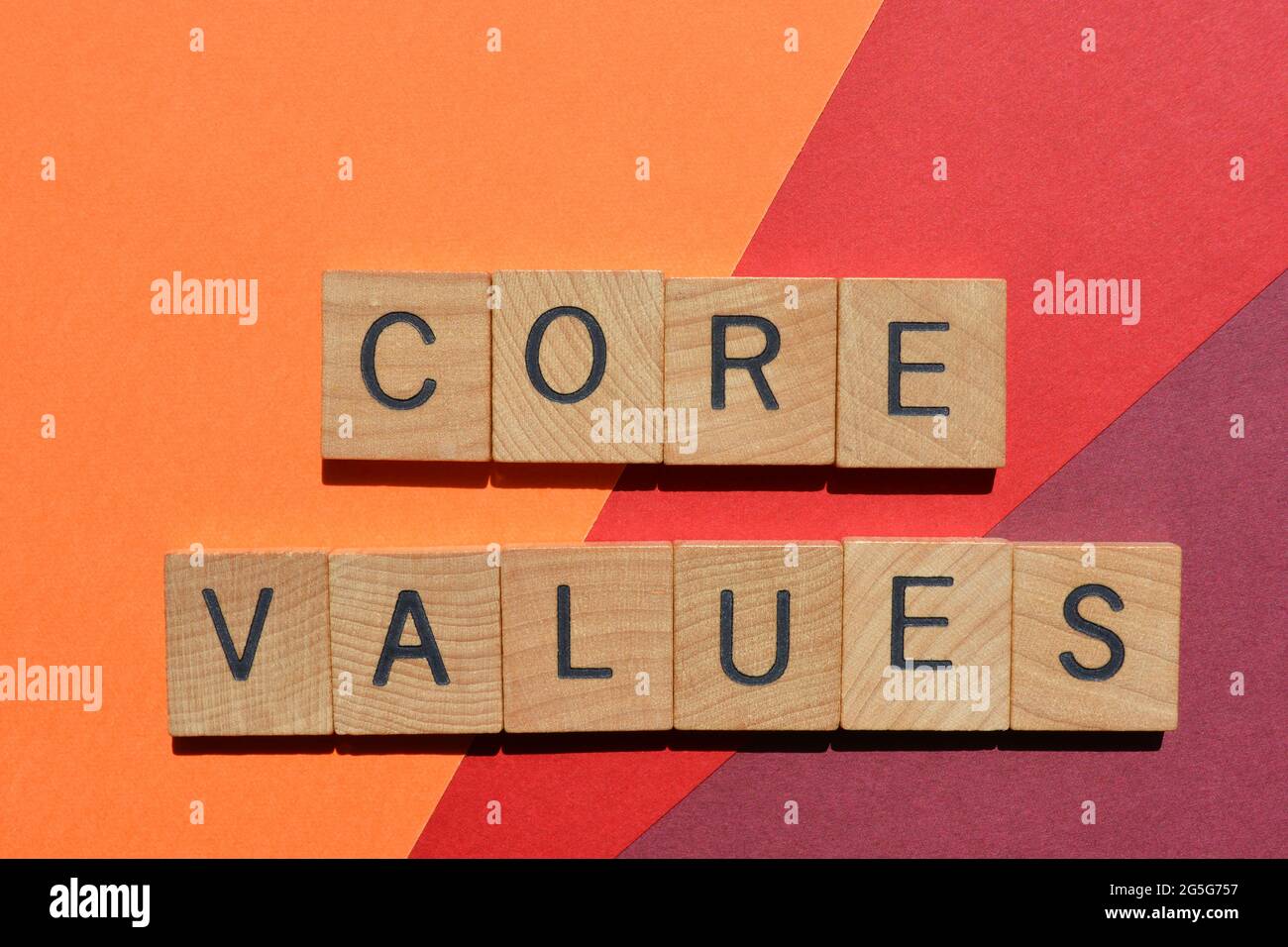 Valori fondamentali, parole in lettere alfabetiche in legno isolate su sfondo colorato Foto Stock