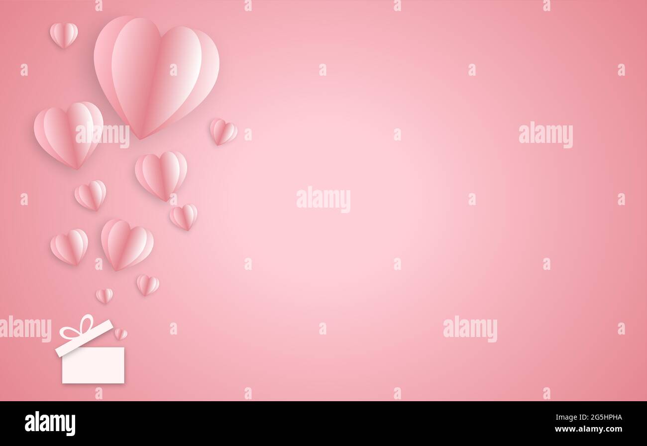 Elementi di carta a forma di cuore su sfondo rosa. Foto Stock