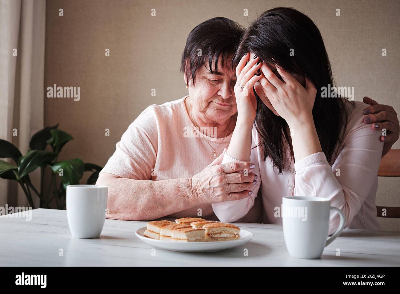 Disturbi mentali e sostegno da parte dei parenti - depressione della figlia e consolazione da sua nonna - il concetto di relazioni familiari e. Foto Stock