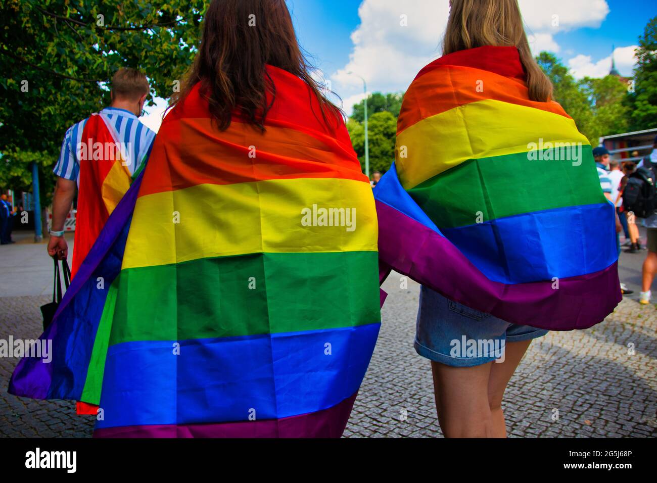 Berlino, Germania - 26 giugno 2021 - due donne portano una bandiera arcobaleno il giorno di Christopher Street (CSD) Foto Stock