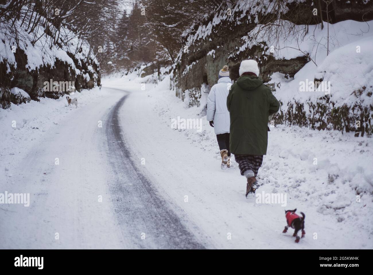 due persone in giacche da neve camminano attraverso la strada coperta da neve inverno ceco Foto Stock