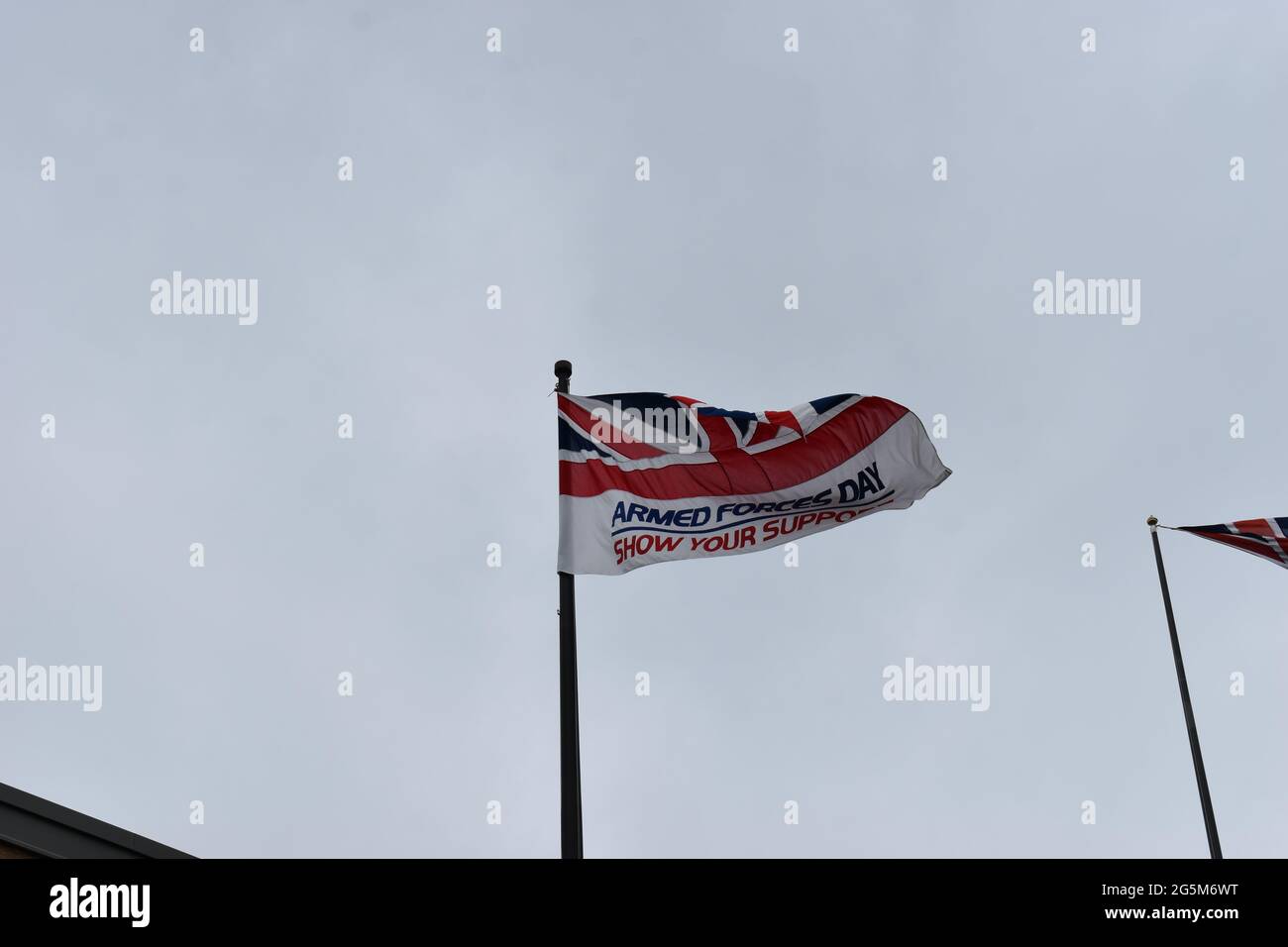 Bandiera del giorno delle forze armate che batte presso gli uffici del Milton Keynes Council. Foto Stock