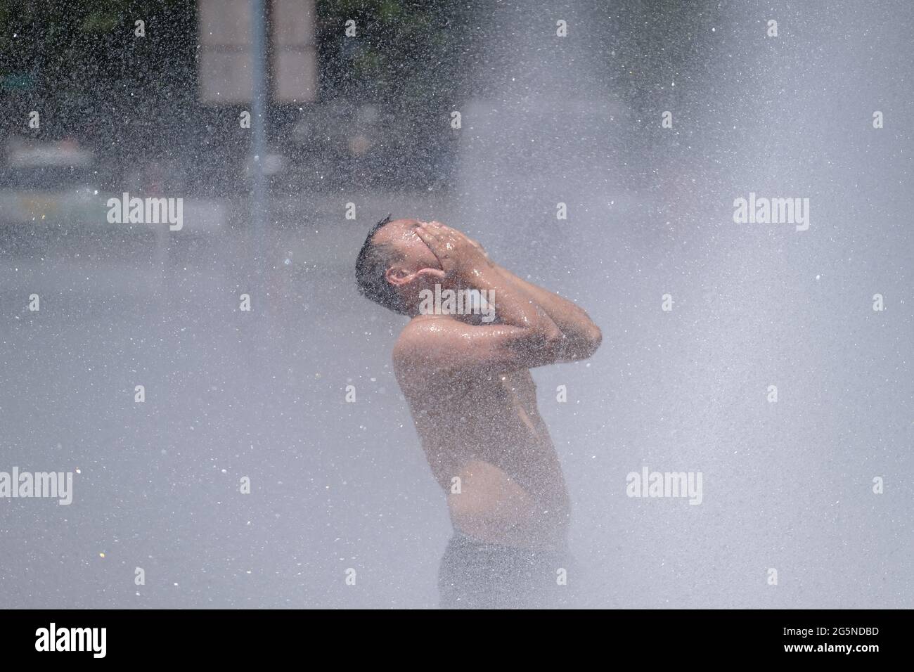 Portland, Stati Uniti. 28 Giugno 2021. Un uomo si raffredda a Salmon Street Springs, nel centro di Portland, Ore., il 28 giugno 2021, dove le temperature raggiunsero un alto di 116 gradi Fahrenheit. (Foto di Alex Milan Tracy/Sipa USA) Credit: Sipa USA/Alamy Live News Foto Stock