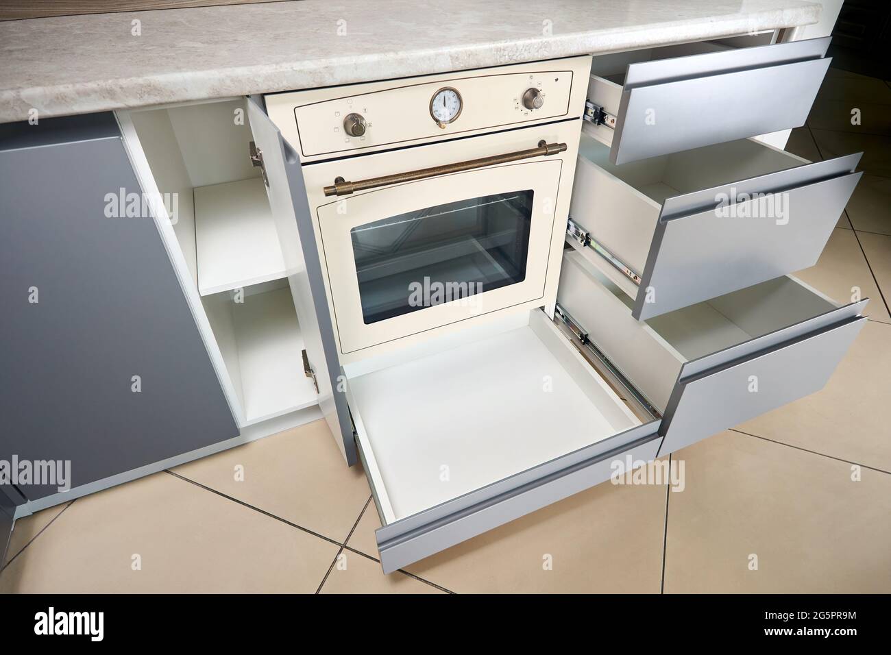 Soluzione per posizionare utensili da cucina in una cucina moderna.  Scaffalature cassetti estraibili orizzontali in armadio per utensili da  cucina sotto uven e Foto stock - Alamy