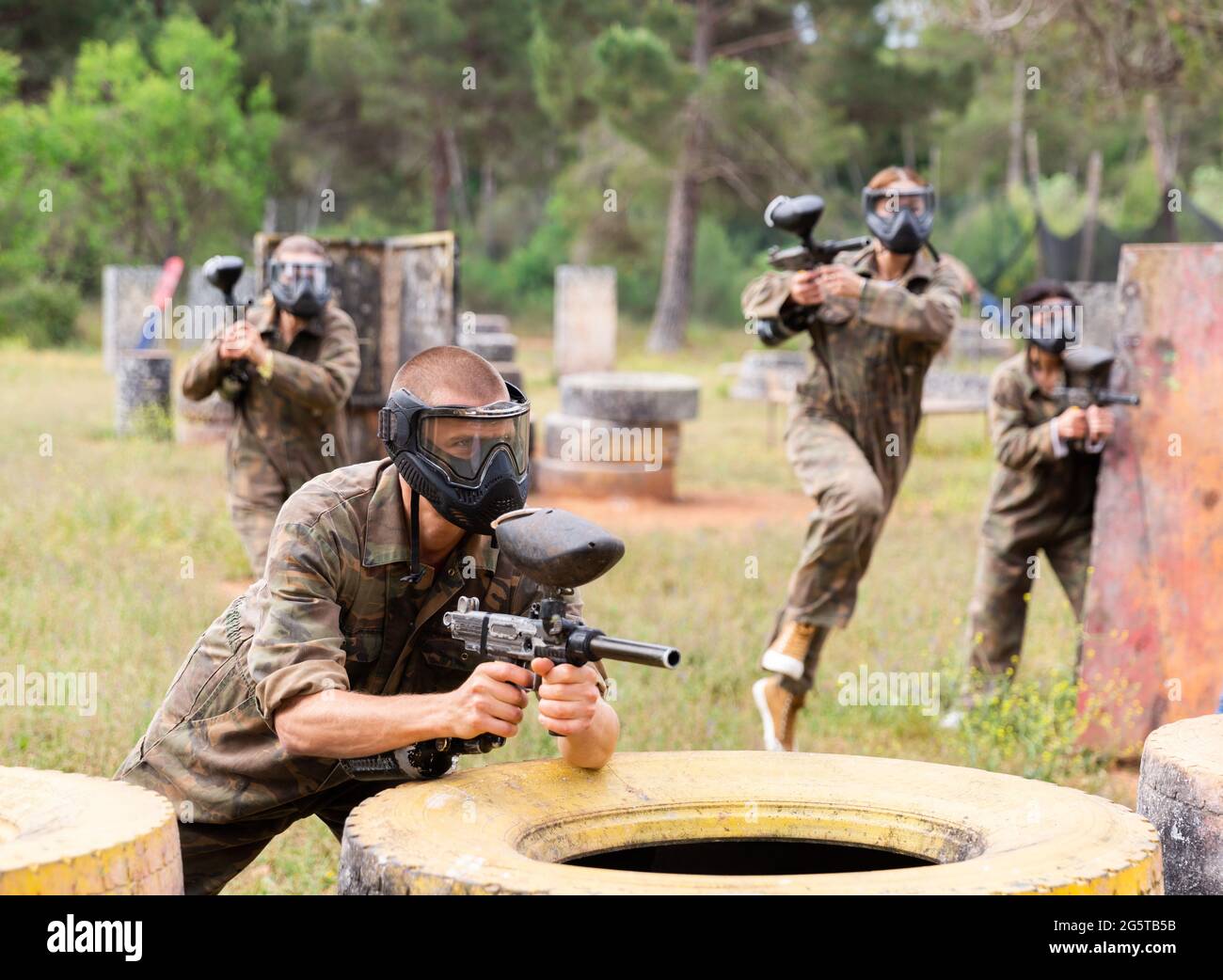 Ritratto dell'uomo in full-gear che gioca a paintball sul campo di battaglia all'aperto Foto Stock