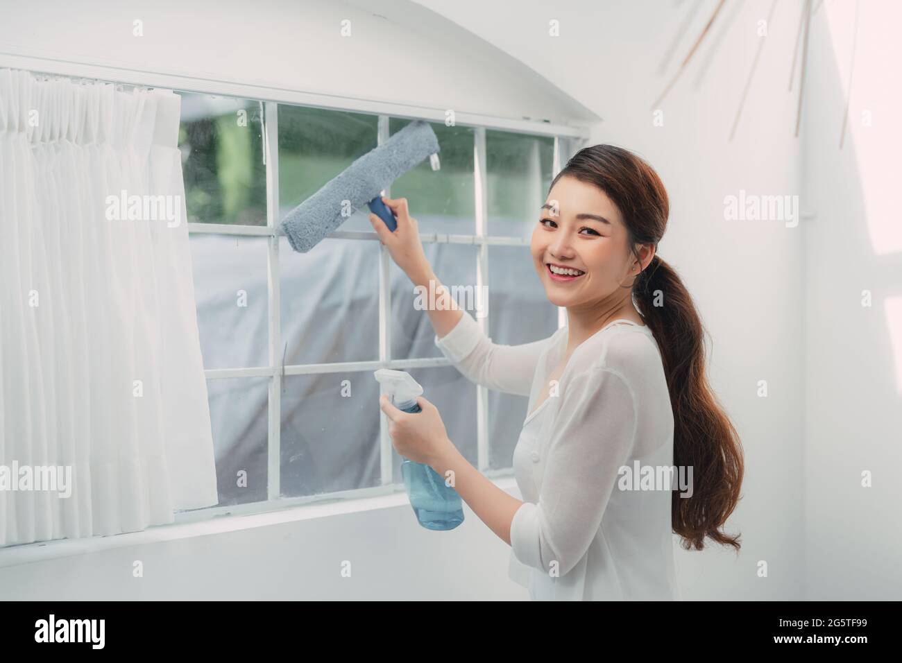Donna pulizia finestra a casa, closeup. Le faccende domestiche Foto Stock