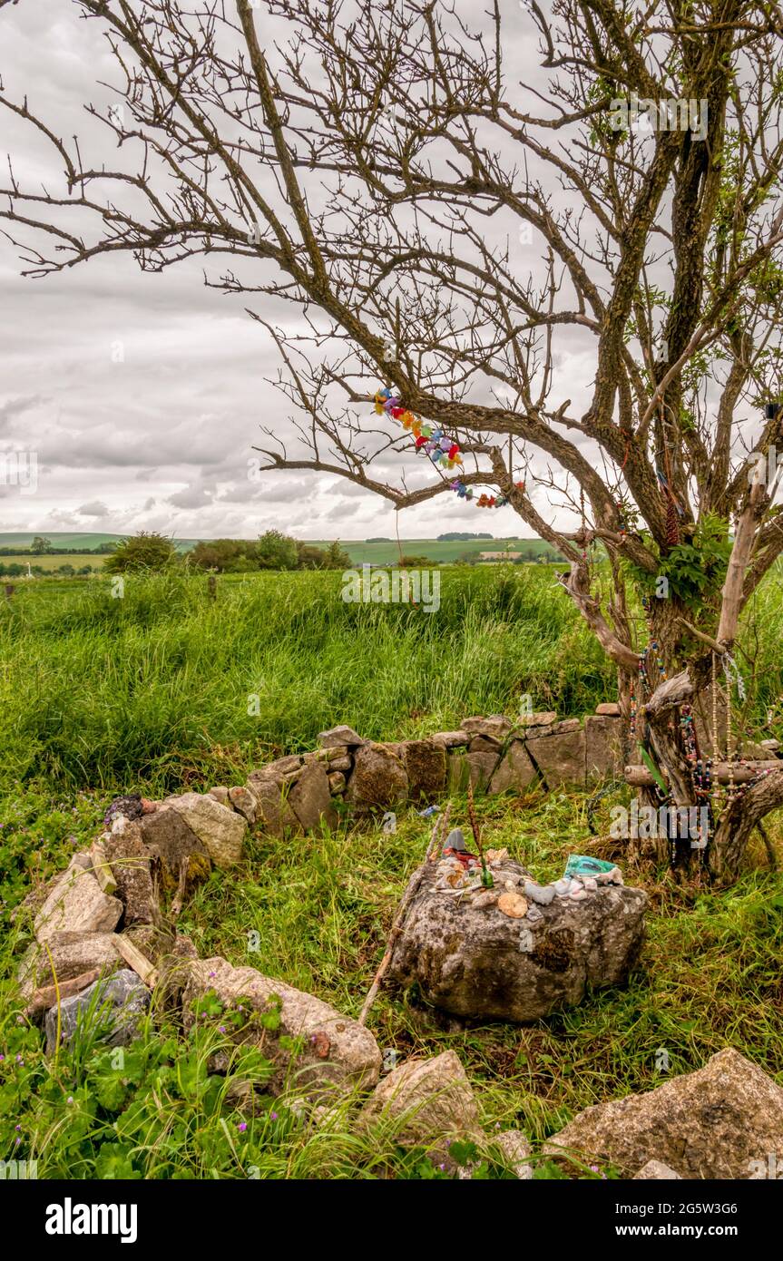 Un piccolo santuario con offerte rituali alla base di un chiodo di garofano sul Ridgeway vicino Avebury nel Wiltshire. Foto Stock