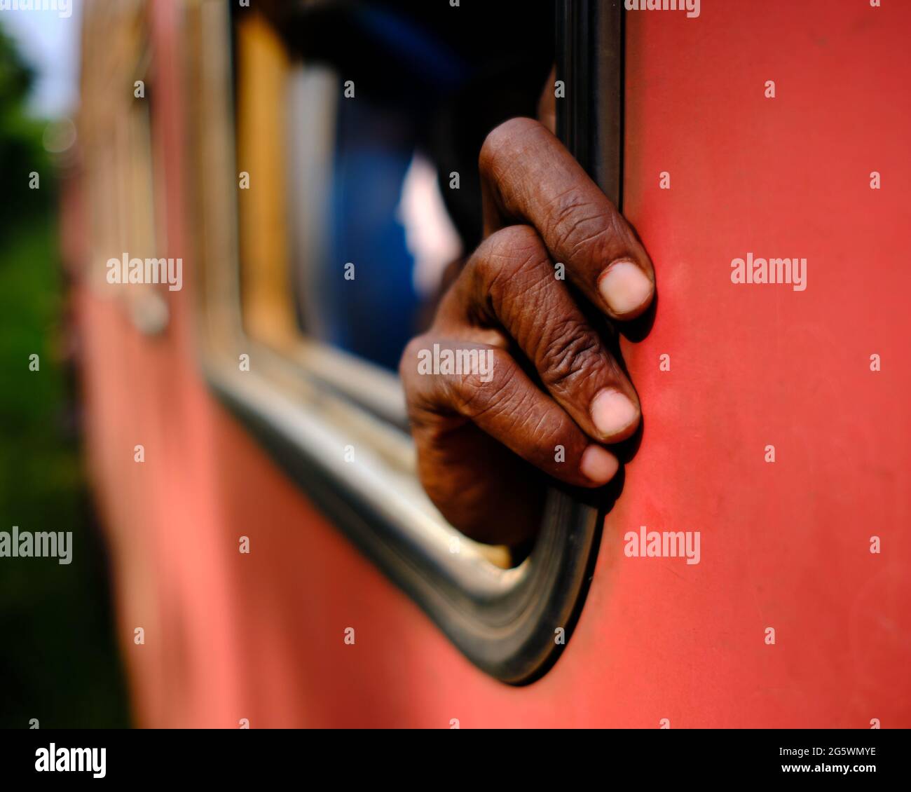 mano di uomo anziano che si stacca dalla finestra del treno in sri lanka Foto Stock