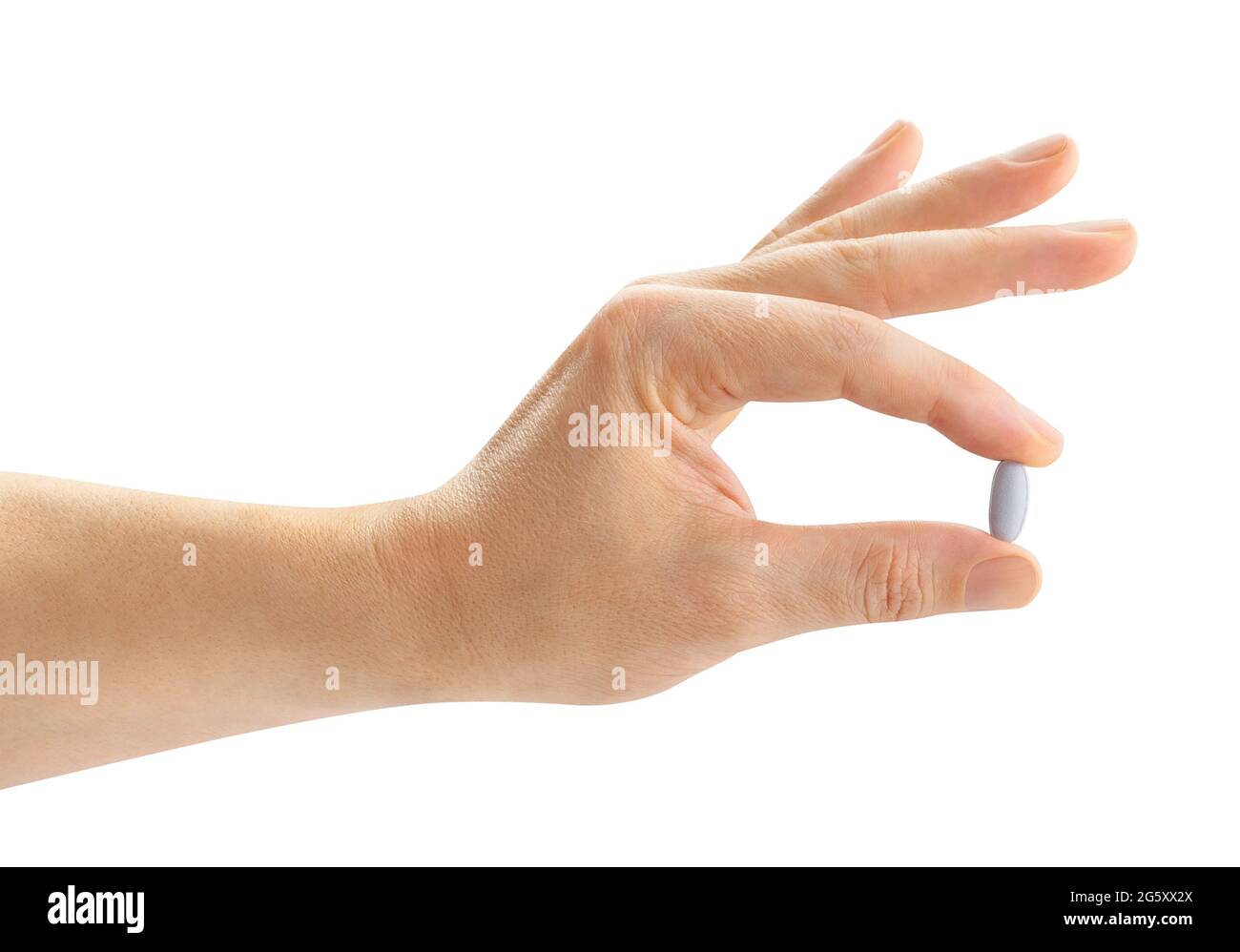 pillola di vitamina nel percorso della mano isolato su bianco Foto Stock