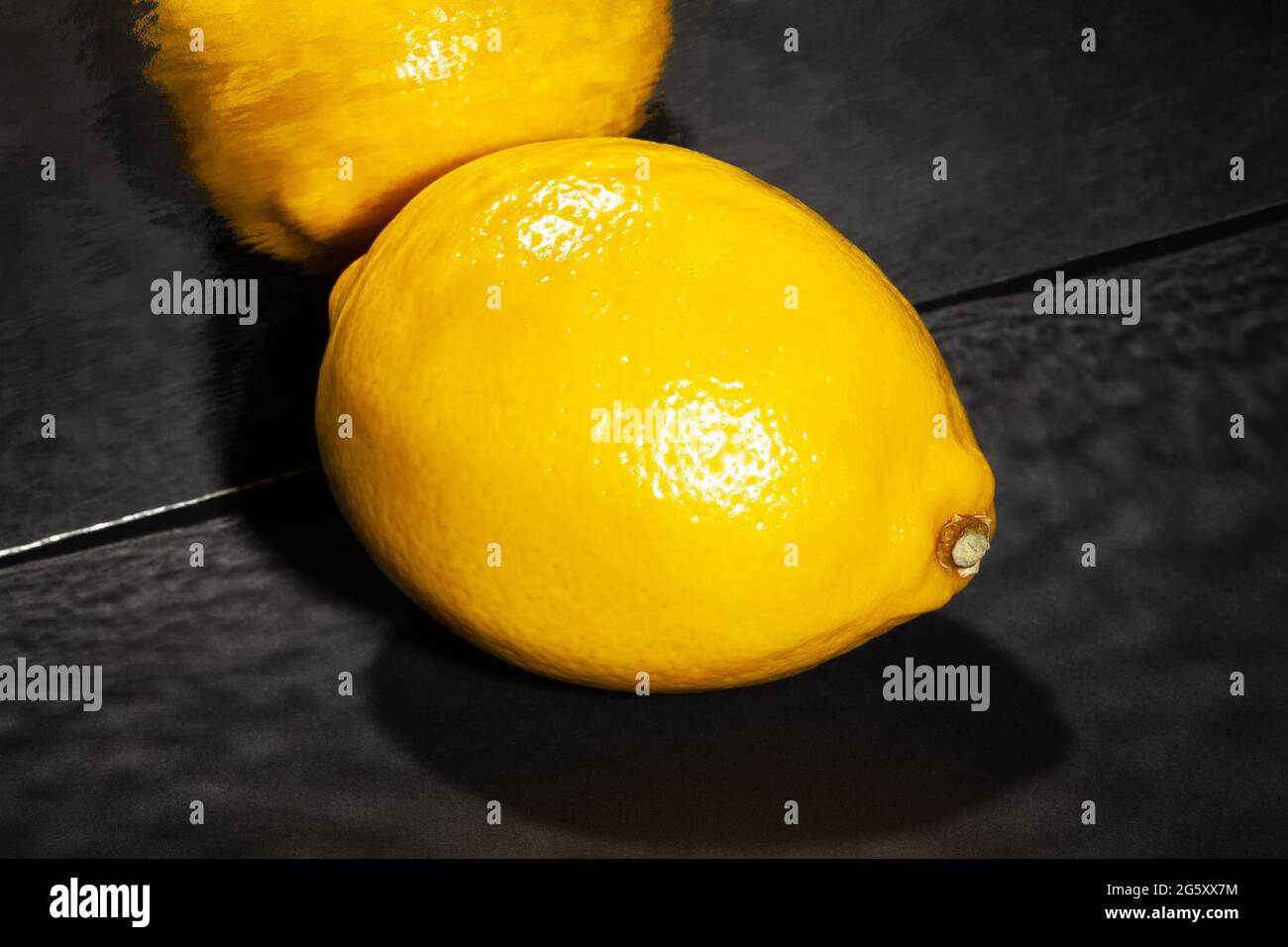 limone specchiato su sfondo nero Foto Stock