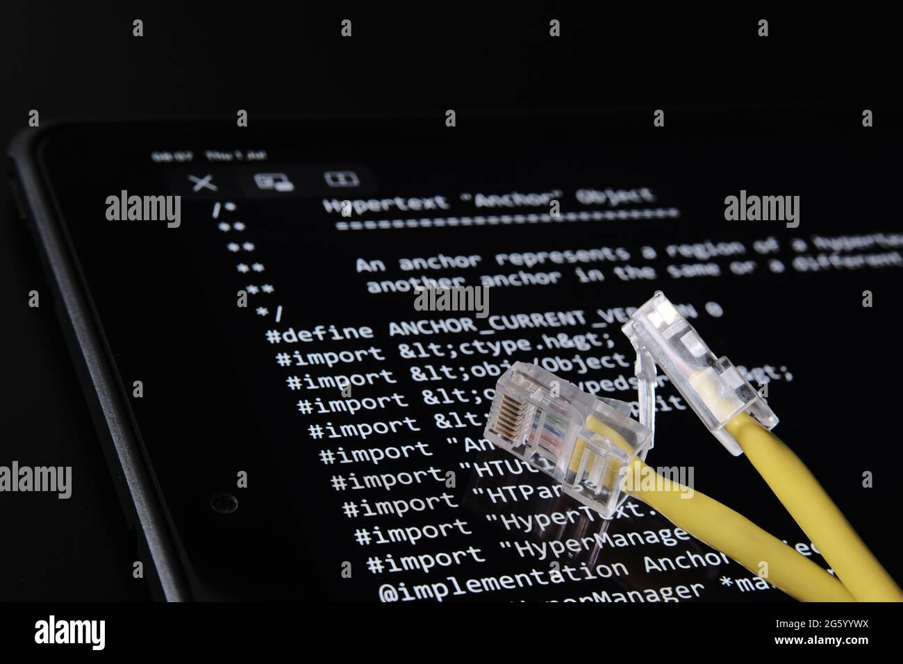 Cavo Internet e codice sorgente World Wide Web che è stato venduto come NFT da Tim Berners Lee visto sullo schermo sfocato di sfondo. Concetto. Stafford, Regno Unito, J. Foto Stock